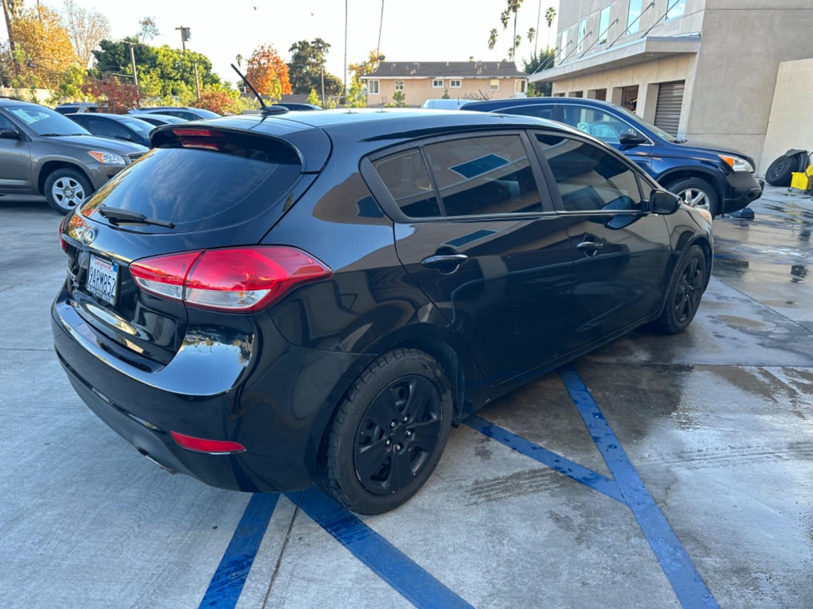 2016 Black /Black Kia Forte 5-Door Cloth (KNAFK5A87G5) with an 4 CYLINDER engine, Automatic transmission, located at 30 S. Berkeley Avenue, Pasadena, CA, 91107, (626) 248-7567, 34.145447, -118.109398 - Embark on a Journey of Style and Efficiency with the 2016 Kia Forte Hatch - Now Available at Our Premier Pasadena, CA Dealership Welcome to our BHPH dealership in Pasadena, CA, where we proudly present the 2016 Kia Forte Hatch, a vehicle that seamlessly blends stylish design, modern technology, a - Photo #4